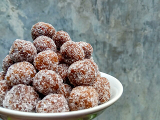 Tamarind candy, placed inside white small plate. Sweet and sour candy made from tamarind paste and...