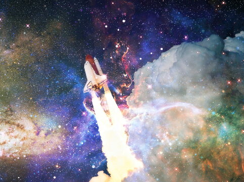 Rockets launch into space on the starry sky. spacecraft flies into space with clouds of smoke. Elements of this image furnished by NASA