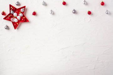 Christmas ball and tinsel and star decoration ornament on white concrete table background