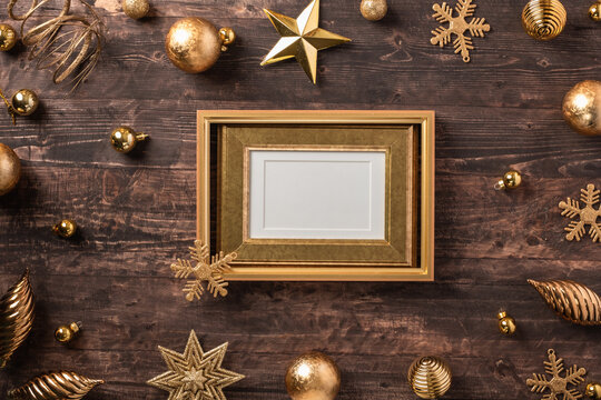 Christmas gold picture frame and bauble,star decoration ornament on brown wood table