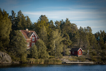 Old traditional red fisherman summer house in Sweden. scandinavian background - obrazy, fototapety, plakaty