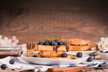 Waffles with blueberries and chocolate cream. 