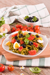 Fusilli pasta with cherry tomatoes, eggs and black olives.
