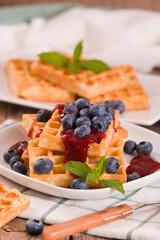 Waffles with blueberries and jam. 