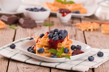 Waffles with blueberries and jam. 