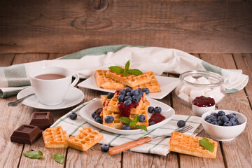 Waffles with blueberries and jam. 