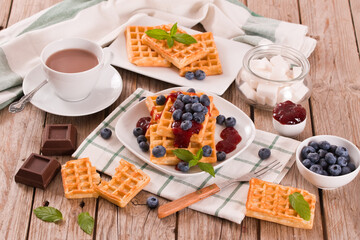 Waffles with blueberries and jam. 