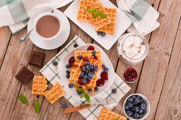 Waffles with blueberries and jam. 