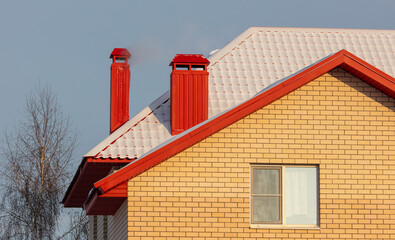 The roof of the house in the snow.