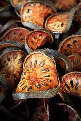 slice of dry bael fruit sold in asian market 