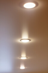 Fototapeta na wymiar White light bulbs on a stretch ceiling