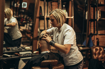 Young bearded man getting haircut by hairdresser