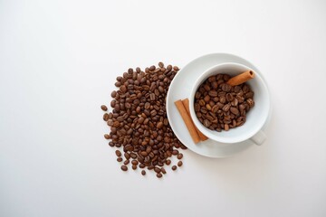 Coffee beans, Cinnamons and cup and saucer on white background. Cafe, Coffee, restaurant design elements. 