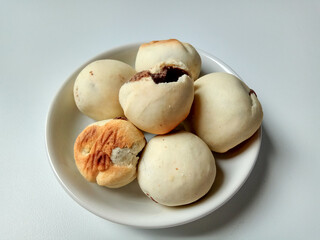 Nopia, is a traditional snack from Banyumas, Indonesia. Made from flour dough filled with red sugar, baked in a furnace. Isolated on white background.