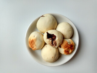 Nopia, is a traditional snack from Banyumas, Indonesia. Made from flour dough filled with red sugar, baked in a furnace. Isolated on white background.