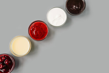 Various sauces in row, copy space. Top view.