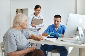 a nurse and a doctor examining a patient hospital professional consultation