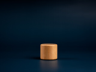 A round wooden pedestal or product display isolated on blue background. Presentation concept. Empty wood podium stage.