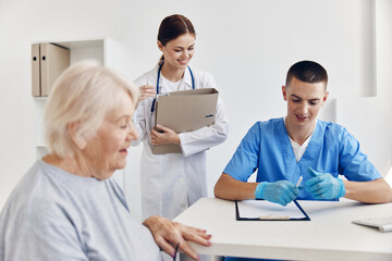 Fototapeta premium elderly woman at the doctor's and nurse's appointments health treatment