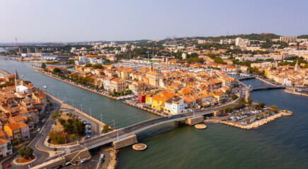 Fototapeta premium Aerial view of Provencale Venice, French seaside town of Martigues on Mediterranean coast overlooking old districts on banks of canals and marina in summer