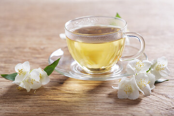 cup of jasmine tea and fresh jasmine flowers