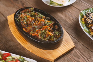 Tzhvzhik - Armenian dish from beef or chicken liver, heart and stomachs with onions and spices  in a bowl on the table. Armenian ,coucasian cuisine