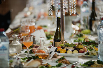 beautifully set table at a wedding banquet with delicious food and alcohol