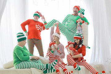 christmas pajama striped party family with kids, new year costumes, fun at home in bed