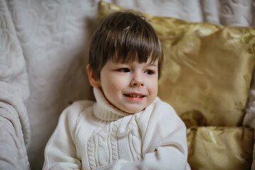 boy sitting on an armchair new year interior studio