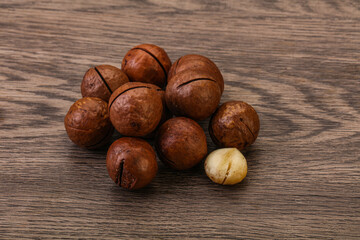 Brown macadamia nut heap over background