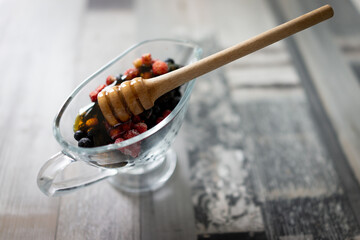 Honey with fresh raw berries forest strawberry. High quality photo