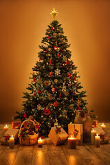 Decorated Christmas Tree with Ornaments, Candles and Gifts in Dark Room Interior. Xmas Holiday Presents Boxes under Fir Tree with Star on Top and Lights