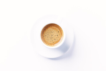 Cup of coffee on bright paper background. Top view. Close up. Copy space.