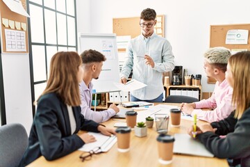 Group of business workers listening hispanic boss man conference at the office.