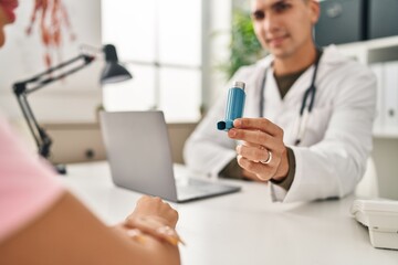 Man and woman doctor and patient having medical consultation holding inhaler at clinic - obrazy, fototapety, plakaty