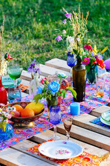 Served table for a wedding dinner in boho chic style decorv