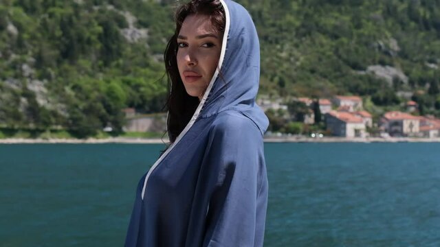 attractive woman in a beautiful landscape. gorgeous attractive woman. stern looking beautiful woman in blue hoodie. Gorgeous woman looking thoughtfully to the Sky. mysterious eyes