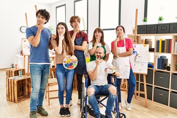 Fototapeta premium Group of young artists people at art studio serious face thinking about question with hand on chin, thoughtful about confusing idea