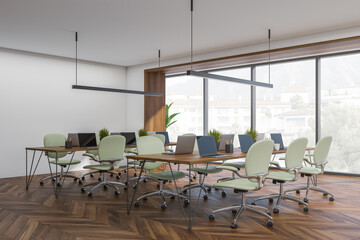 Corner view of white and green coworking space