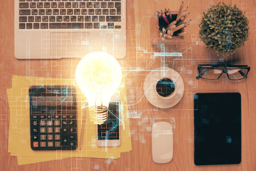 Double exposure of bulb drawing over table with phone. Top view. Concept of idea.