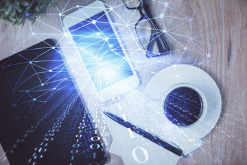 Double exposure of technology theme drawing over work table desktop. Top view. Global data analysis concept.