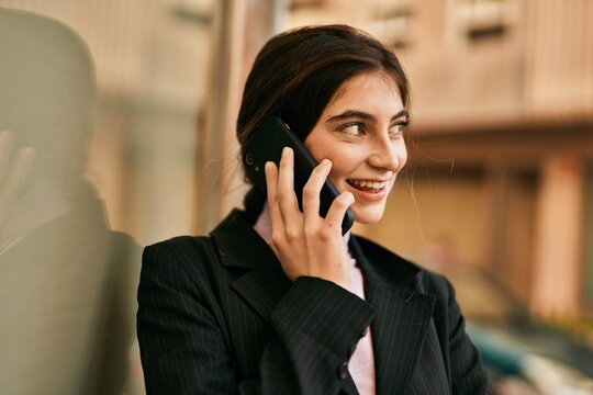 Young beautiful businesswoman smiling happy talking on the smartphone at the city.