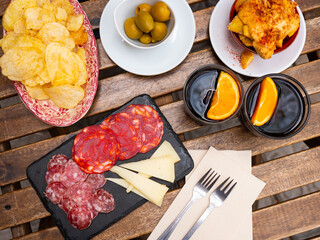 Two glasses of fortified red vermouth traditionally garnished with orange wedges served with...