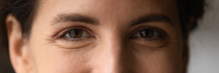 Close up cropped shot of young smiling woman face with beautiful eyes. Good vision and eye care....