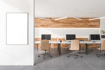 Bright office room interior with empty white poster, six desktops