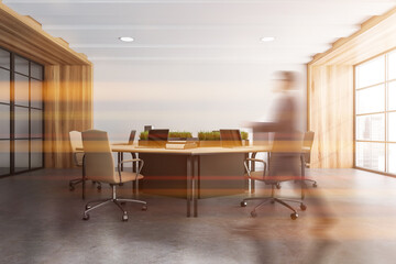 Businessman is walking inside bright office room interior