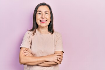 Fototapeta premium Middle age hispanic woman with arms crossed gesture celebrating crazy and amazed for success with open eyes screaming excited.