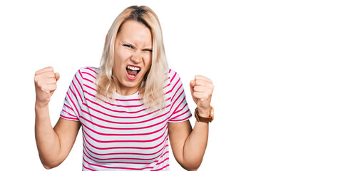 Fototapeta na wymiar Young caucasian woman wearing casual clothes angry and mad raising fists frustrated and furious while shouting with anger. rage and aggressive concept.