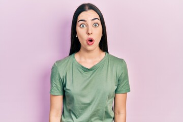 Beautiful woman with blue eyes wearing casual t shirt afraid and shocked with surprise expression, fear and excited face.