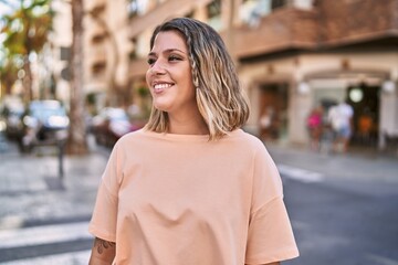 Fototapeta premium Young hispanic woman smiling confident at street